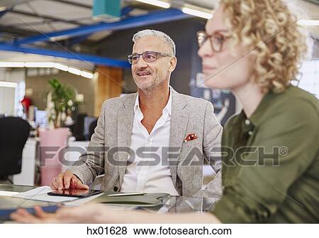 Business people listening in meeting View Large Photo Image Stock Photo - Business people listening in meeting. Fotosearch
