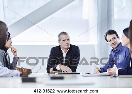Stock Image - Business people meeting in conference room. Fotosearch