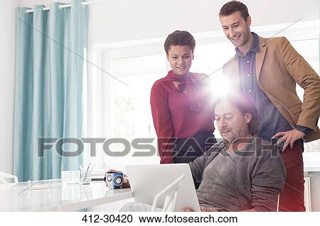 Business people sharing laptop in office meeting View Large Photo Image Stock Image - Business people sharing laptop in office meeting. Fotosearch