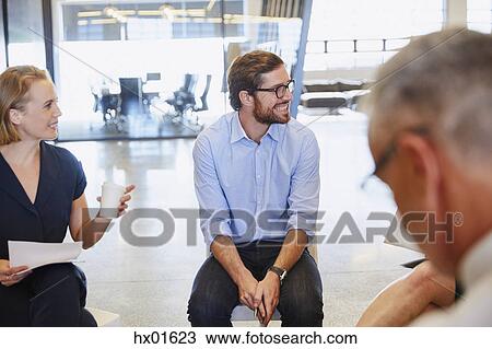 Business people smiling and listening in meeting View Large Photo Image Stock Image - Business people smiling and listening in meeting. Fotosearch