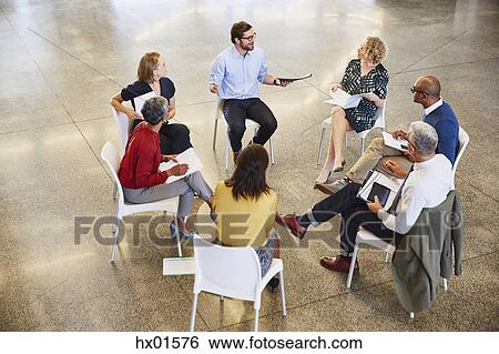 Business people talking in circle meeting View Large Photo Image Stock Photograph - Business people talking in circle meeting. Fotosearch