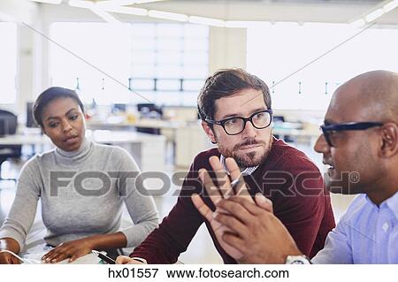 Stock Photo - Business people talking in meeting. Fotosearch