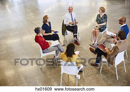 Business people talking in meeting circle View Large Photo Image Stock Photo - Business people talking in meeting circle. Fotosearch