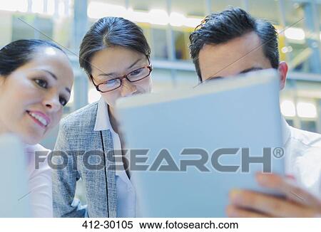 Business people using digital tablet in office View Large Photo Image Stock Photography - Business people using digital tablet in office. Fotosearch