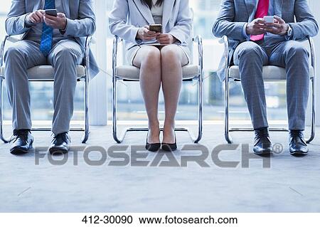Business people with cell phones waiting in a row View Large Photo Image Stock Image - Business people with cell phones waiting in a row. Fotosearch