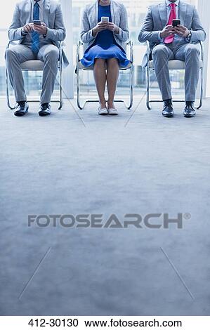 Business people with cell phones waiting in a row View Large Photo Image Stock Image - Business people with cell phones waiting in a row. Fotosearch