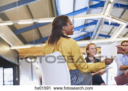 Business people with paperwork in meeting View Large Photo Image Stock Image - Business people with paperwork in meeting. Fotosearch
