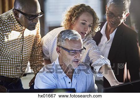 Business people working at computer View Large Photo Image Stock Photo - Business people working at computer. Fotosearch