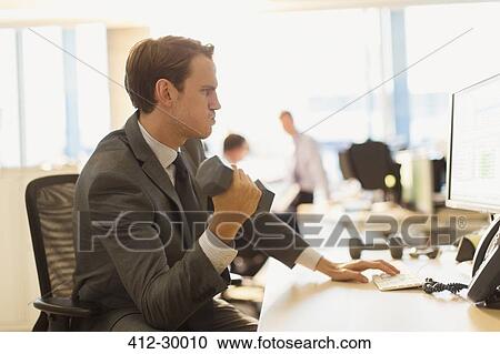 Businessman doing biceps curls with dumbbell at computer in office View Large Photo Image Stock Image - Businessman doing biceps curls with dumbbell at computer in office. Fotosearch