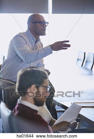 Businessman gesturing and explaining in meeting View Large Photo Image Picture - Businessman gesturing and explaining in meeting. Fotosearch