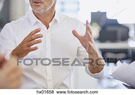 Stock Photo - Businessman gesturing in meeting. Fotosearch