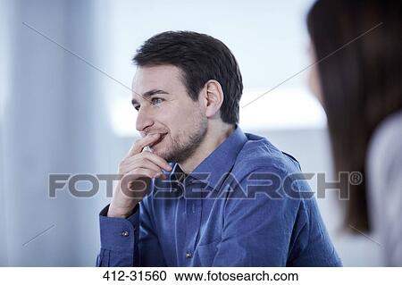 Businessman listening in meeting View Large Photo Image Stock Image - Businessman listening in meeting. Fotosearch