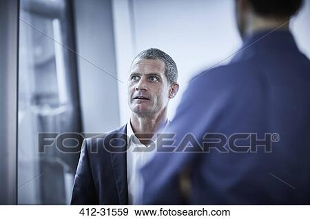 Businessman listening in meeting View Large Photo Image Stock Photo - Businessman listening in meeting. Fotosearch