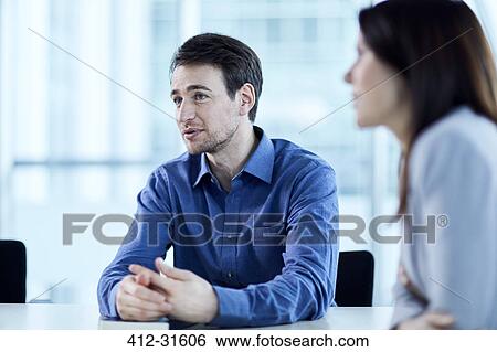 Stock Photograph - Businessman listening in meeting. Fotosearch