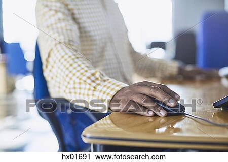 Businessman using computer mouse at desk View Large Photo Image Stock Image - Businessman using computer mouse at desk. Fotosearch