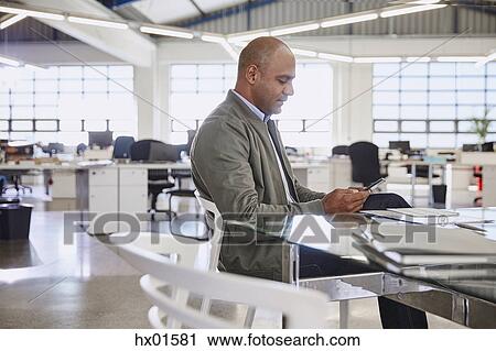 Businessman using digital tablet in office View Large Photo Image Stock Image - Businessman using digital tablet in office. Fotosearch
