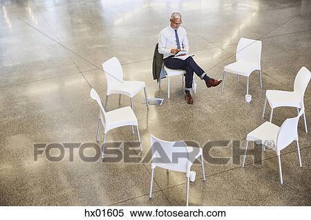 Businessman with digital tablet waiting for circle meeting View Large Photo Image Stock Photography - Businessman with digital tablet waiting for circle meeting. Fotosearch