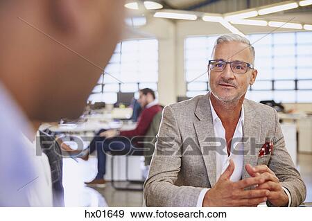 Businessmen talking in meeting View Large Photo Image Stock Photo - Businessmen talking in meeting. Fotosearch