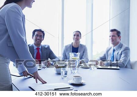Businesswoman leading meeting in conference room View Large Photo Image Stock Image - Businesswoman leading meeting in conference room. Fotosearch