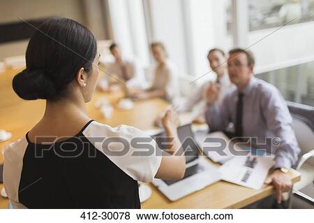Businesswoman leading meeting in conference room View Large Photo Image Stock Photo - Businesswoman leading meeting in conference room. Fotosearch