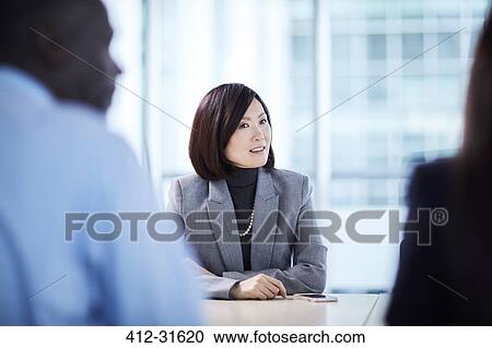 Businesswoman listening in meeting View Large Photo Image Stock Image - Businesswoman listening in meeting. Fotosearch