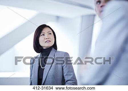 Businesswoman listening to businessman View Large Photo Image Picture - Businesswoman listening to businessman. Fotosearch