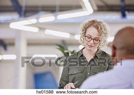 Businesswoman looking down in meeting View Large Photo Image Stock Photo - Businesswoman looking down in meeting. Fotosearch