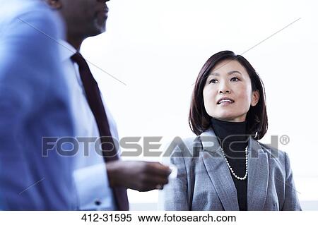 Businesswoman talking to colleague View Large Photo Image Stock Photography - Businesswoman talking to colleague. Fotosearch