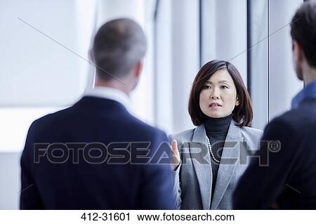 Businesswoman talking to colleagues View Large Photo Image Stock Image - Businesswoman talking to colleagues. Fotosearch
