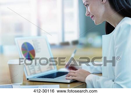 Stock Photograph - Businesswoman working at laptop. Fotosearch
