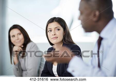 Businesswomen listening to businessman in meeting View Large Photo Image Stock Photograph - Businesswomen listening to businessman in meeting. Fotosearch
