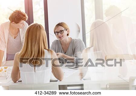Stock Photo - Businesswomen meeting in conference room. Fotosearch