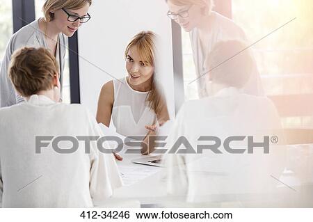 Businesswomen meeting talking in conference room View Large Photo Image Stock Photograph - Businesswomen meeting talking in conference room. Fotosearch