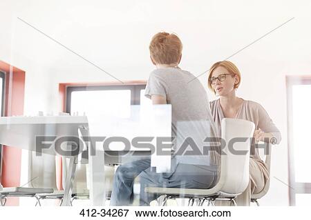 Stock Photo - Businesswomen talking in conference room meeting. Fotosearch