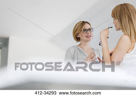 Businesswomen talking in office View Large Photo Image Stock Image - Businesswomen talking in office. Fotosearch