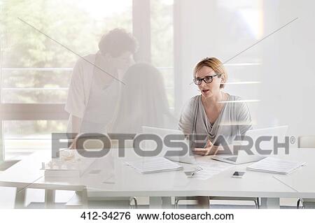 Stock Photograph - Businesswomen working meeting in conference room. Fotosearch