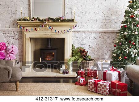 Christmas tree, gifts and decorations near fireplace in living room View Large Photo Image Stock Photo - Christmas tree, gifts and decorations near fireplace in living room. Fotosearch