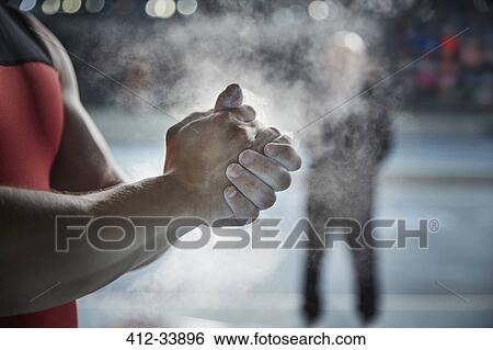 Close up male weightlifter applying chalk powder on hands View Large Photo Image Stock Photograph - Close up male weightlifter applying chalk powder on hands. Fotosearch