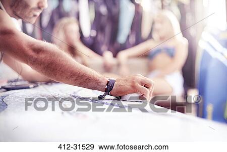 Close up man waxing surfboard View Large Photo Image Stock Photo - Close up man waxing surfboard. Fotosearch