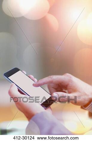 Picture - Close up of businessman dialing cell phone. Fotosearch