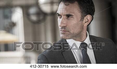 Close up pensive corporate businessman looking away View Large Photo Image Stock Photography - Close up pensive corporate businessman looking away. Fotosearch