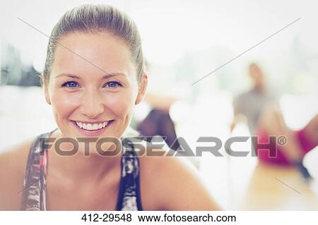 Stock Photo - Close up portrait smiling woman in exercise class. Fotosearch