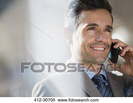 Close up smiling corporate businessman talking on cell phone View Large Photo Image Stock Photography - Close up smiling corporate businessman talking on cell phone. Fotosearch