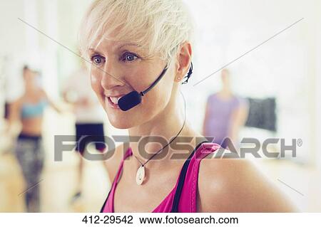 Close up smiling fitness instructor with headset View Large Photo Image Stock Image - Close up smiling fitness instructor with headset. Fotosearch