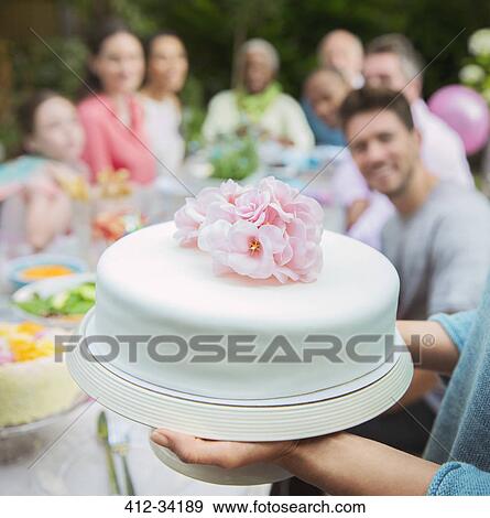 Stock Photo - Close up white fondant cake with pink flowers. Fotosearch