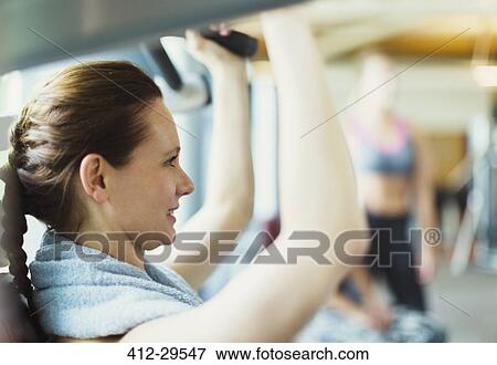 Close up woman using exercise equipment at gym View Large Photo Image Stock Photo - Close up woman using exercise equipment at gym. Fotosearch