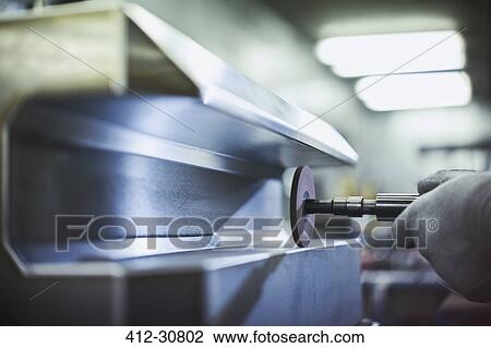 Close up worker sanding steel in steel factory View Large Photo Image Stock Image - Close up worker sanding steel in steel factory. Fotosearch