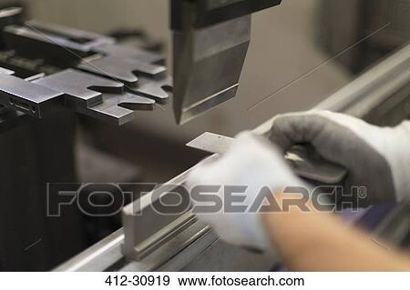 Close up worker using machinery in steel factory View Large Photo Image Stock Photo - Close up worker using machinery in steel factory. Fotosearch