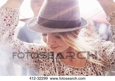 Close up young blonde woman with fedora dancing at music festival View Large Photo Image Stock Photo - Close up young blonde woman with fedora dancing at music festival. Fotosearch