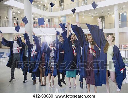 College graduates in cap and gown throwing caps overhead View Large Photo Image Stock Image - College graduates in cap and gown throwing caps overhead. Fotosearch